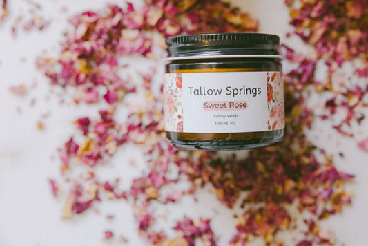 Jar of Tallow Springs Sweet Rose product on a background with colorful petals